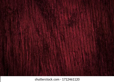 Dark burgundy wood texture. Texture of old dried plywood. Mahogany background for design.