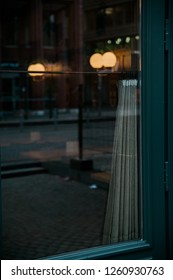 Dark Cafe Window With Lights And Reflections In It