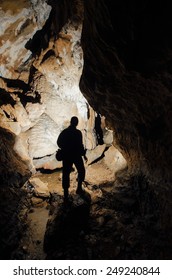 Dark Cave With Explorer Silhouette