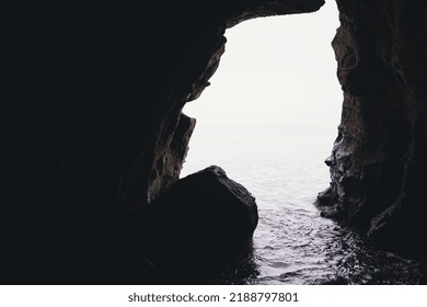 Dark Cave On Misty Water