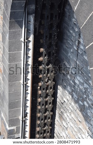 dark chain of a sluice gate