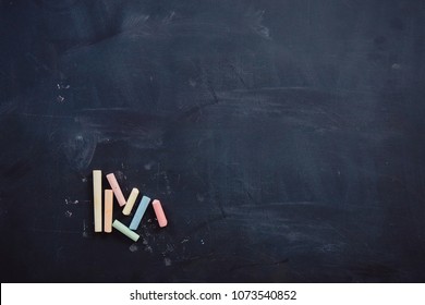 Dark Chalk Board With Colored Pencils For Drawing. Copy Space