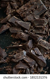 Dark Chocolat Cut In Small Pieces On A Black Granite Surface