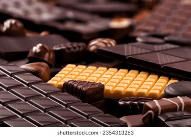 dark chocolate bars and candy background, delicious cocoa dessert.