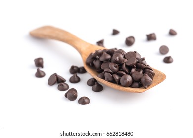 Dark Chocolate Chips In Spoon Isolated On White Background.