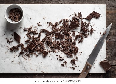 Dark Chocolate Chopped On Marble  Background. Overhead View.