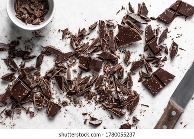 Dark Chocolate Chopped On Marble  Background. Overhead View.