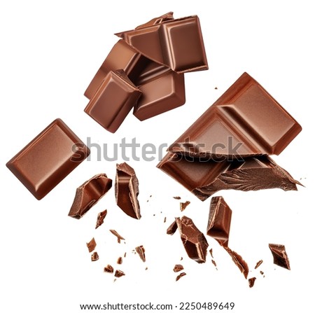 Dark chocolate chunks isolated on white background. Collection. Flying Chocolate pieces, shavings and cocoa crumbs Top view. Flat lay. Pattern
