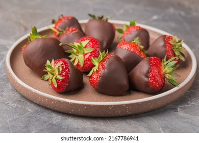 Dark chocolate covered strawberries on ceramic plate. Gourmet food. - Powered by Shutterstock