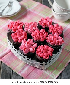 Dark chocolate cupcakes decorated with pink Tulips using Russian piping tip