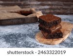 Dark chocolate espresso brownies, white and gray textured background. Baked