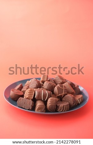 dark chocolate on a plat red background 