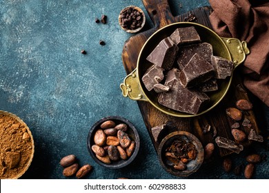 Dark chocolate pieces crushed and cocoa beans, culinary background, top view - Shutterstock ID 602988833