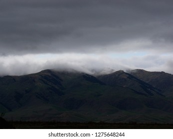 a dark cloud over the mountains