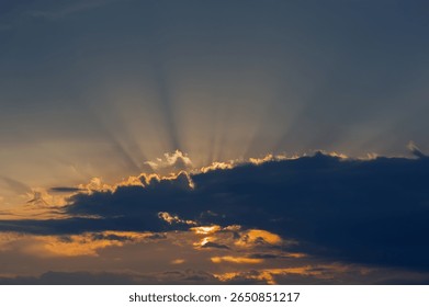 Dark cloud and sun rays at sunset. Natural background. Web banner.
