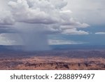 Dark clouds accumulating to rain storm over Split Mountain Canyon seen from Grand View Point Overlook near Moab, Island in the Sky District, Canyonlands National Park, San Juan County, Utah, USA