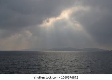 dark clouds and beautifull sun lights over the ocean coast