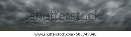 Dark clouds before a thunderstorm, tornado, hurricane, in the vast sky