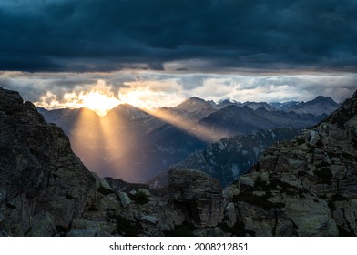 Dark clouds during a dramatic sunset in the European Alps.
