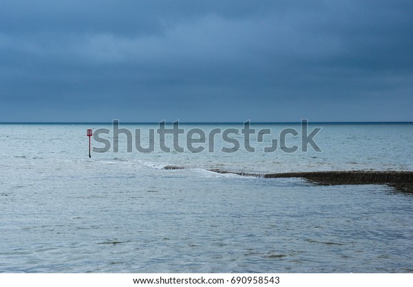 Dark\
clouds and light sea at Dawlish, Devon, England,\
UK
