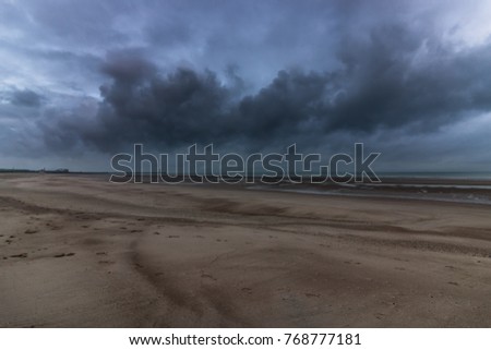 Dark clouds over beach in Dunkirk
