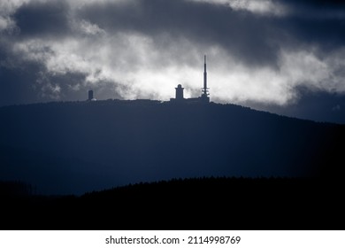 Dark clouds over the mountain. Harz mountain Brocken in mystical light and fog