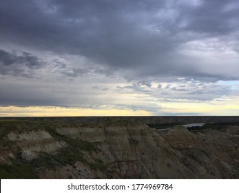 Dark Clouds Over River In Canadian Badlands