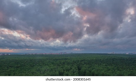 Dark Clouds With Red Sunset Light Float Over The Summer Evening Forest, Time Lapse