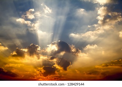 Dark clouds with sun rays over sea.