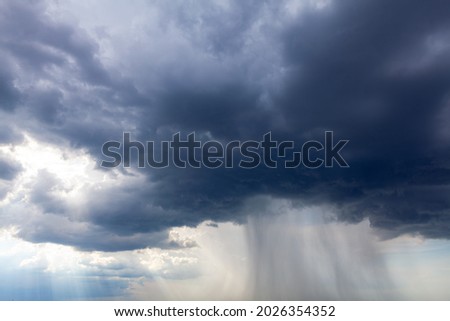 Dark clouds with torrential rain . Heavy rain stream from black clouds  Stock photo © 