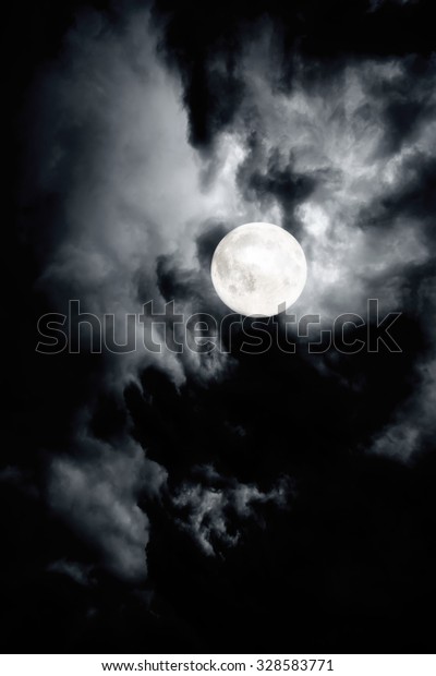 Dark cloudy sky of full\
moon night
