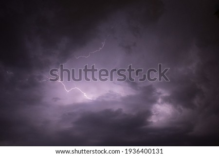 A dark cloudy sky with thunder lightning bolt strike