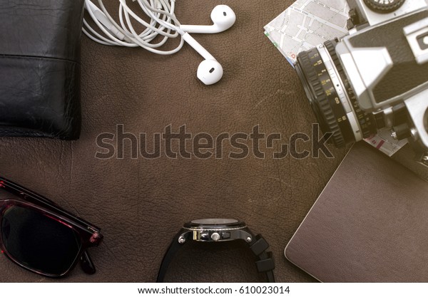 Dark concept black hand phone with earphone on\
leather background