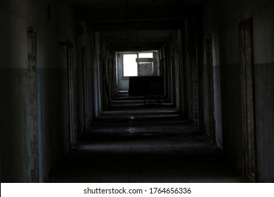 A Dark Corridor In An Abandoned Building. A Cluttered Corridor In Ruins. Abandoned Building. Horror. Dark Room. Long Passage.