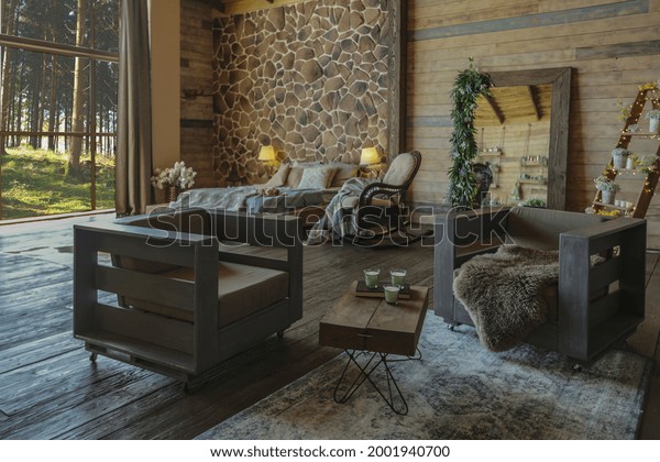 dark cozy interior of big country wooden house,\
wooden furniture and animal furs. huge panoramic window and very\
high ceiling.