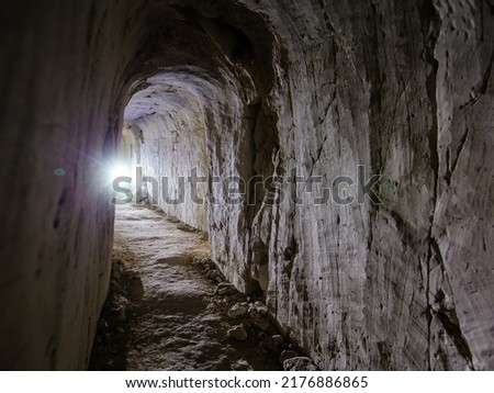 Dark creepy abandoned underground chalky cave temple.