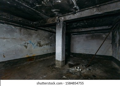 Dark And Creepy Dirty Abandoned Underground Basement Afrer Fire. Walls In Black Soot