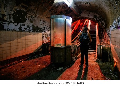 Dark and creepy old abandoned subway station. Broken escalator.