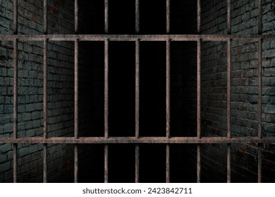 Dark and dim space in an empty prison cell with old brick walls. and old rusted iron bars, prison interior The concept of fear and lack of freedom