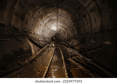 Dark dirty abandoned subway tunnel with rusty railway. - Powered by Shutterstock