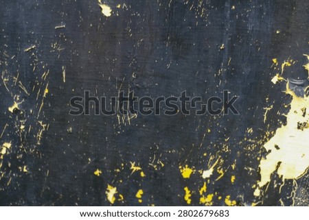 Dark distressed metal texture featuring scratches, peeling paint, and worn surface. Ideal as a grunge background, industrial texture, or abstract design element.