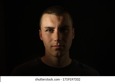 Dark and dramatic portrait of a serious and professional young man