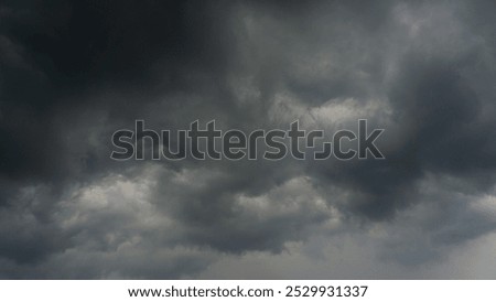 dark dramatic sky with black stormy clouds before rain or snow as abstract background, extreme weather