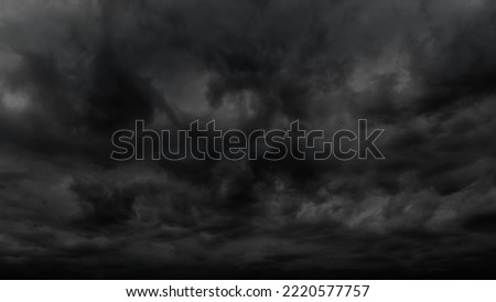 dark dramatic sky with stormy clouds before rain or snow as abstract background, extreme weather