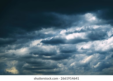Dark, dramatic storm clouds forming in the sky, signaling an approaching thunderstorm. Moody weather scene with heavy cloud coverage and atmospheric tension. Selective focus.