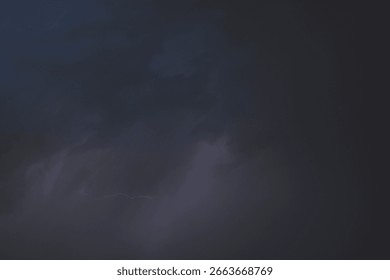 Dark, dramatic storm clouds gather on the horizon, hinting at an approaching thunderstorm. The sky is a canvas of intense grays and deep blues, with a powerful sense of impending weather. This image c