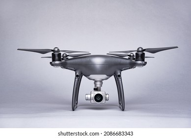 Dark drone on a gray background. UAV close up.