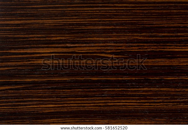 Dark ebony wood
background, exclusive natural texture with patterns. Extremely high
resolution photo.