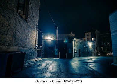 Dark and eerie urban city alley at night
