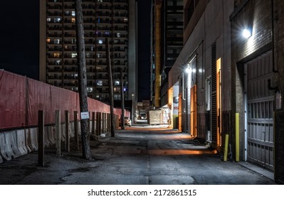 Dark empty back alley at night - Shutterstock ID 2172861515